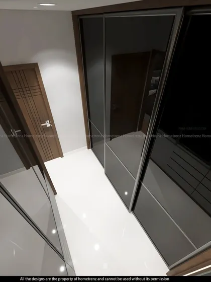 Another angle of the walk-in closet, showing the sleek, handle-less design of the wardrobe doors.