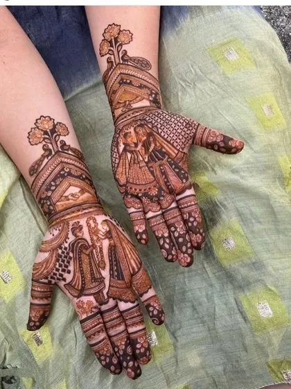An engagement or bridal design featuring couple portraits. One hand shows the groom and the other shows the bride, each framed beautifully and connected with intricate patterns up the arm.