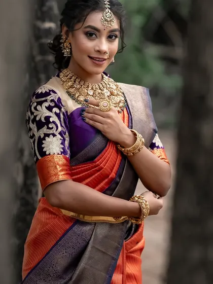 The model's confident smile and beautiful attire make for a captivating image.