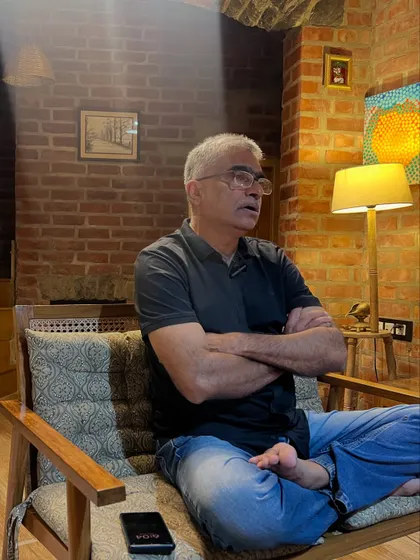 In a moment of reflection during an online talk, I sit in a comfortable cross legged posture. This embodies the integration of yogic principles into every aspect of life, even while using modern technology.
