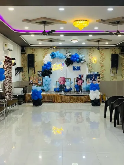 A wide view of the Boss Baby themed party hall decoration. This shows how I can transform an entire space, including the stage, entrance, and photo displays, to fit your chosen theme.