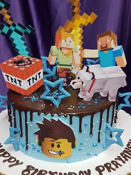 For the gamer in your life, this cake combines the worlds of Minecraft and Roblox. With a chocolate drip, edible characters, and themed toppers, it's a fun and action-packed birthday surprise.