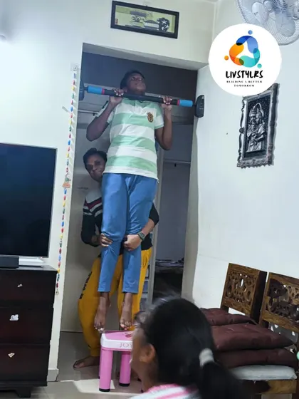 Another young client gets assistance with his pull-up practice. Building strength from a young age sets the foundation for a healthy, active life.