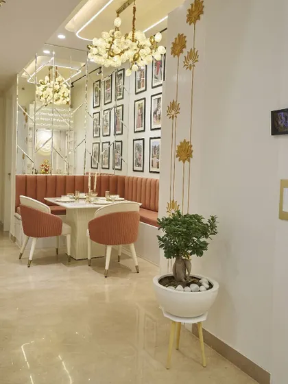 A view of the dining nook from the hallway, showing how it's neatly tucked into a corner. The gold lotus wall decals are a beautiful, budget-friendly decor idea.
