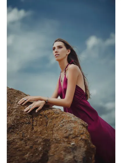 In this color version of the outdoor series, the rich magenta of the dress stands out against the earthy tones of the rock and the blue sky, creating a powerful visual contrast.
