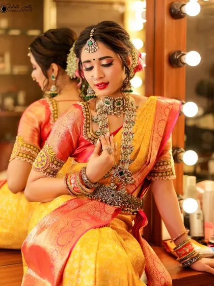 A similar shot to 58, capturing the final moments of preparation. The reflection in the mirror adds depth, showing both the model and her likeness in one frame.