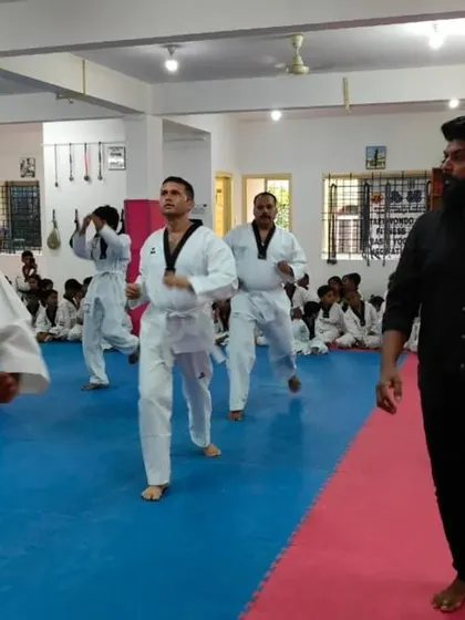 A senior student leads the class in practice.