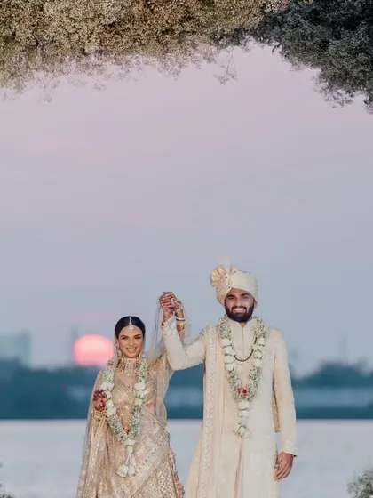 An eternal love, sealed with vows under the sunset sky in Kochi. Even the sun made a special appearance, casting a radiant glow upon this ethereal white floral mandap, adding the perfect touch to a magical sunset wedding.