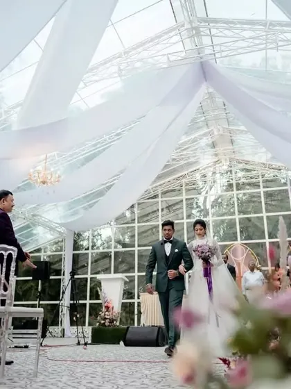 The bride's entrance. This moment captures the serene and elegant atmosphere we created, with soft drapery and lush florals framing the aisle.