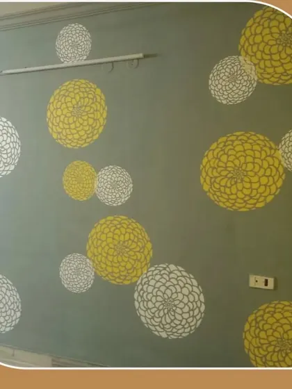 A playful and cheerful wall stencil with yellow and white floral patterns on a grey background, brightening up the entire room.
