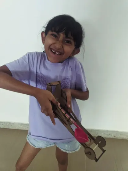 She is so proud of making this DIY rubber-powered car, a fantastic project from our summer camp.