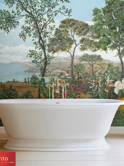 The 'Baobab' wallpaper by Nobilis creates a stunning, immersive bathroom experience. The panoramic design features a vibrant coastal landscape with lush trees and flowers, turning the space into a tropical oasis.