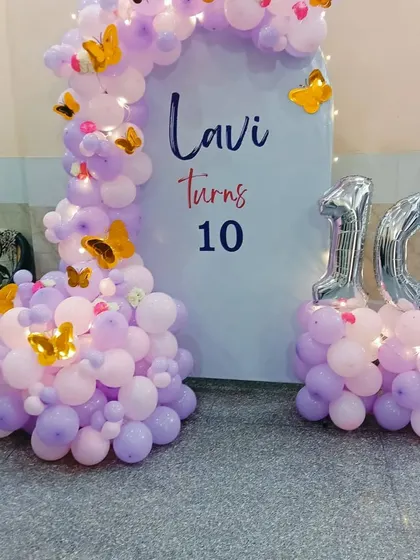 A sweet butterfly theme for a 10th birthday. I used a custom backdrop for "Lavi turns 10" and a balloon arrangement in shades of pink and lavender, with gold butterfly accents and large silver foil numbers.