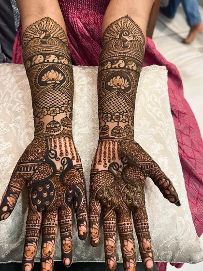 A dense and intricate design featuring peacocks, elephants, and lotuses, with fully covered fingertips.