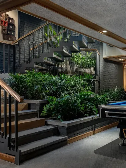 For the Tarun Residence remodel, we carved a sunken courtyard into the earth and surrounded it with lush greenery. This intervention breathes light and life into the lower level, transforming a once underutilized space into a vibrant, nature-filled core.
