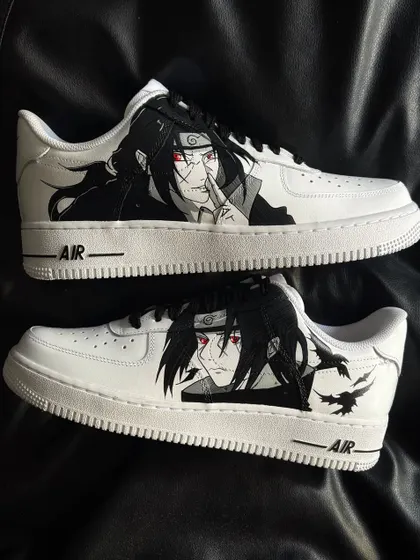 A pair of white Nike Air Force 1s with a striking custom design of Itachi Uchiha from Naruto.