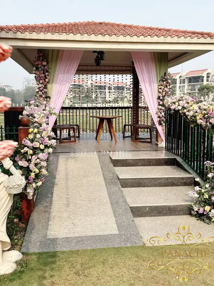 A charming gazebo at the venue, decorated with pastel drapes and floral arrangements, creating another picturesque spot.