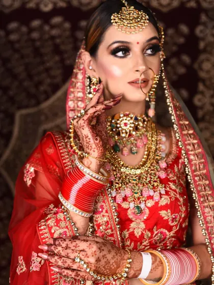 A side profile showcasing the intricate details of the multi-colored necklace and matching maang tikka.