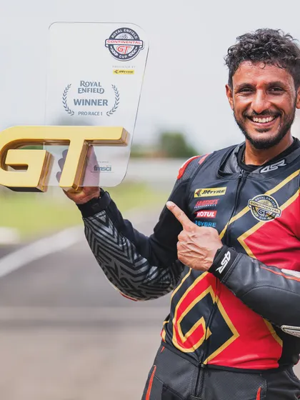 Holding the winner's trophy from the Royal Enfield GT Cup. This victory was about more than just the result; it was about rediscovering my love for the sport and enjoying the process of racing.