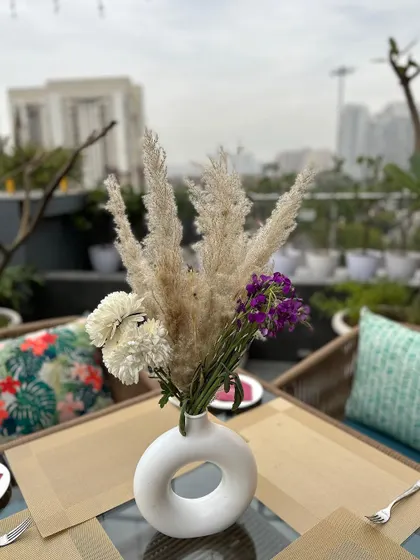 A close-up of a simple, modern centerpiece on a rooftop table.