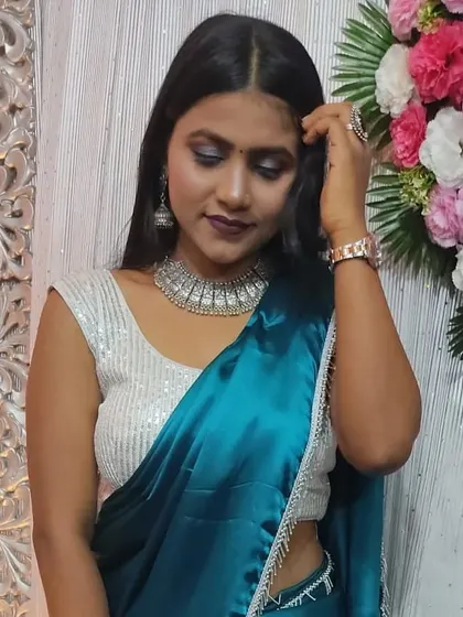 A perfect party look. I created a smokey eye with a bold lip, paired with oxidized silver jewelry, which looks stunning with her satin blue saree.