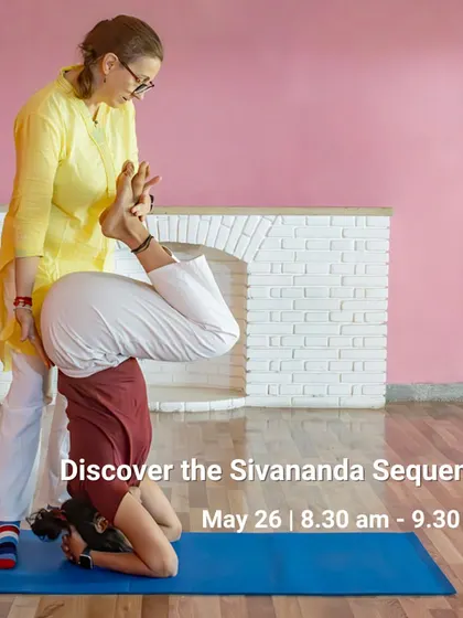 In our workshops, you receive personalized guidance to safely explore challenging postures. Here, an instructor provides support in Sirsasana (Headstand), ensuring proper alignment and building confidence for a safe and rewarding practice.