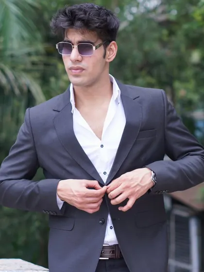 A simple yet classic charcoal grey blazer, perfect for layering over a shirt for a semi-formal or smart casual look.