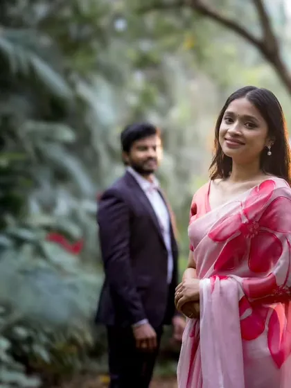 A classic portrait in a park, with the bride in focus and her partner in the background. This composition adds depth and tells a story of anticipation and love.