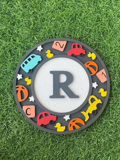 This "R" monogram is filled with classic toys like cars, ducks, and blocks, making it a perfect piece for a child's room.