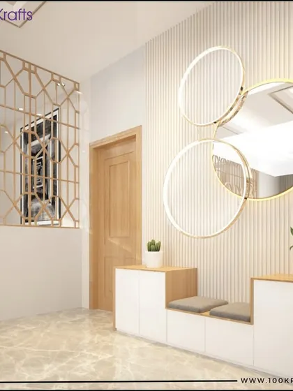 A contemporary foyer with a functional shoe cabinet that includes seating, set against a fluted wall with statement circular mirrors.