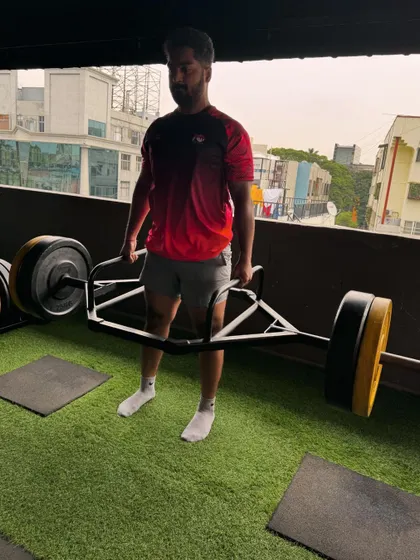 A client completes a heavy trap bar deadlift, showcasing his progress and dedication.