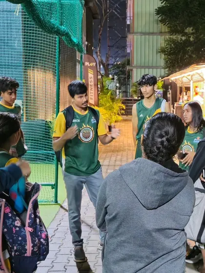 A post-game huddle with the Hoopstars. These discussions help reinforce lessons and build team chemistry.