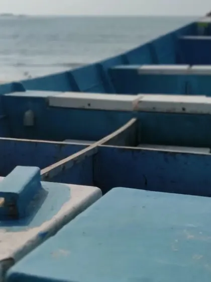 A close-up of a traditional fishing boat on Malpe beach, capturing the coastal culture of the region.