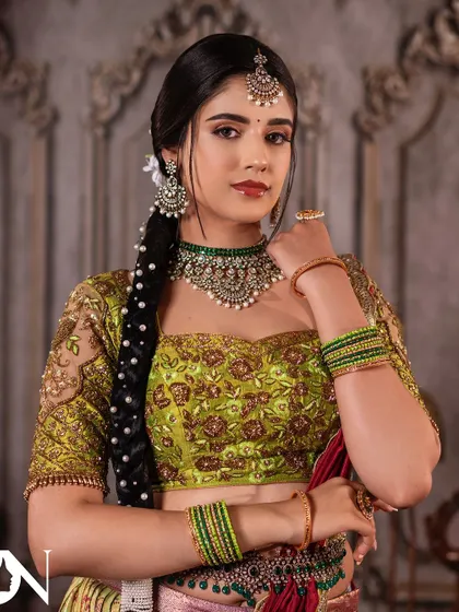This model looks stunning in a close-up shot, highlighting the intricate details of the Kundan choker and matching earrings. A perfect choice for a sangeet or reception.