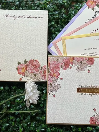 A beautiful floral invitation set with inserts in different pastel colors. The gold foil borders add a touch of elegance.