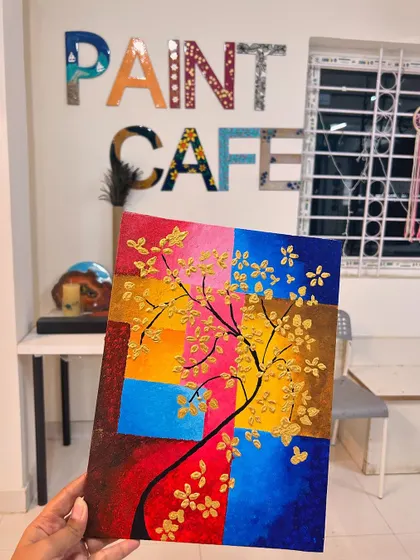 A vibrant, abstract tree painting with a textured, colorful block background and golden flowers.