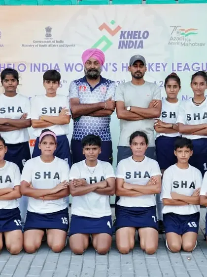 The U-16 girls' team stands with their coaches after a hard-fought match. Every game is a learning experience that builds character and team spirit.