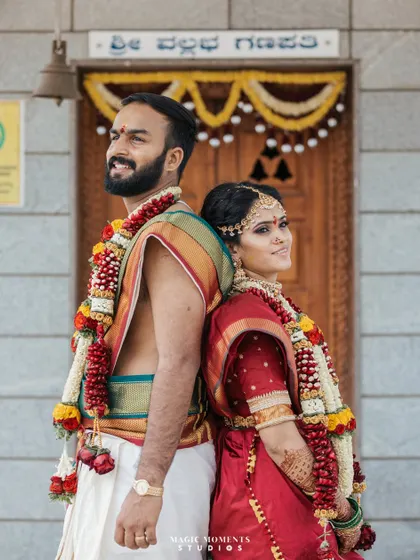 A classic back-to-back portrait of the bride and groom in front of the temple doors. This pose is both stylish and symbolic of their partnership.