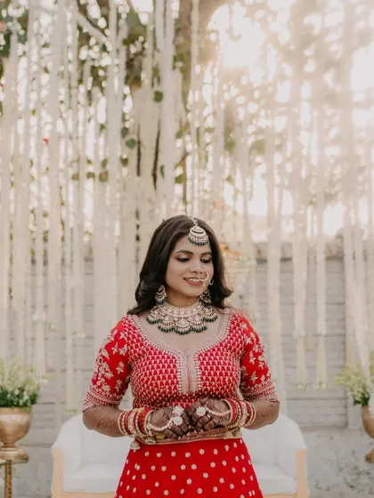 A candid moment of the bride looking happy and relaxed. The makeup is fresh and glowing, perfect for a long day of celebrations.