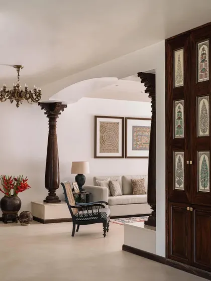 A view through the living space, showing how antique pillars and arched openings are used to frame views and define spaces.
