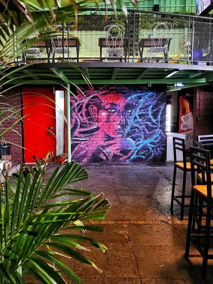 A wider view showing the mural in the context of the multi-level pub, visible from both the ground floor and the mezzanine.