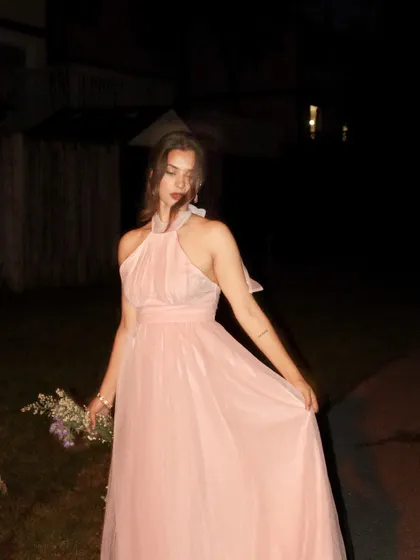 A slightly blurred, artistic shot of the pink tulle dress from Jardinvue.