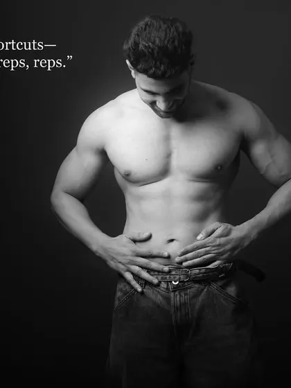 An artistic black and white fitness portrait. The quote "There are no shortcuts—everything is reps, reps, reps" adds a motivational message to the powerful visual.
