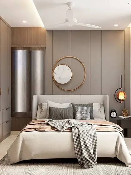 A calm and neutral-toned bedroom with floor-to-ceiling wardrobes. A circular mirror hangs above the bed, and a unique pendant light adds a touch of modern design.