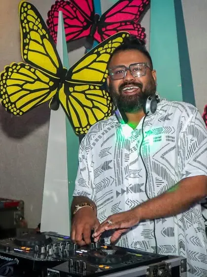 In my element, mixing tracks and watching the crowd respond. A great, clear shot of me at the DJ console, focused on delivering the perfect beat for the party.