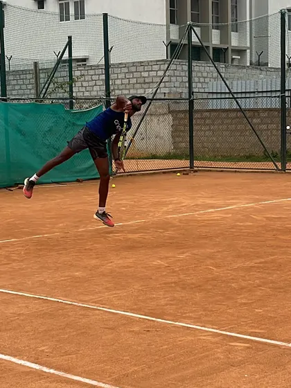 A dynamic action shot of a jump serve, capturing the power and athleticism we cultivate in our players.