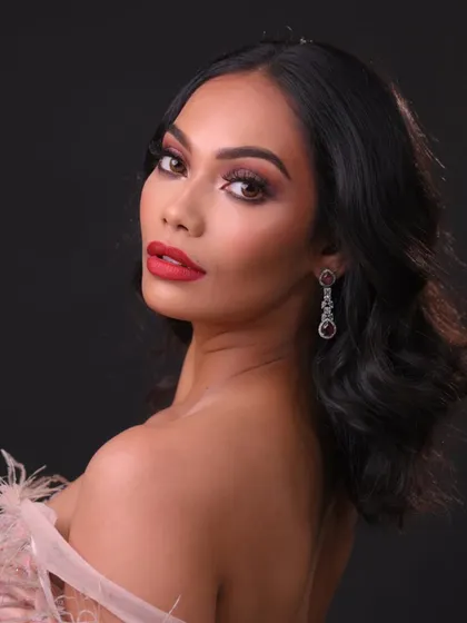 A glamorous evening look with a bold red lip and soft waves. This is a classic style every artist needs to master.