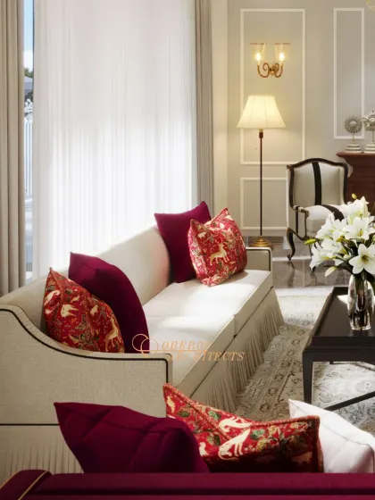 A living room that exudes traditional luxury with its rich red fabrics, classic furniture silhouettes, and ornate details.