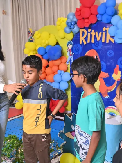 Giving every child their moment to shine. Here, I'm passing the mic to one of the guests at a birthday party, making the activities interactive and encouraging everyone to participate.