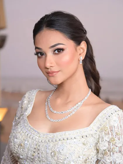 A fusion of untamed beauty and luxury. The soft glam makeup allows her natural beauty to shine, while the diamond jewelry and detailed outfit add that perfect touch of elegance.